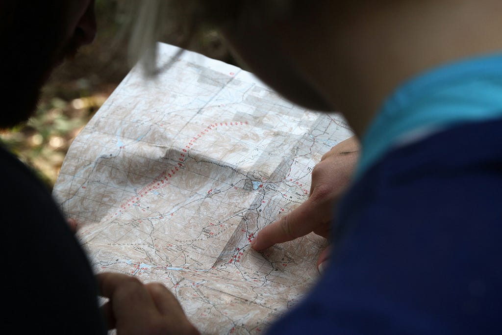 Two people studying a map outdoor